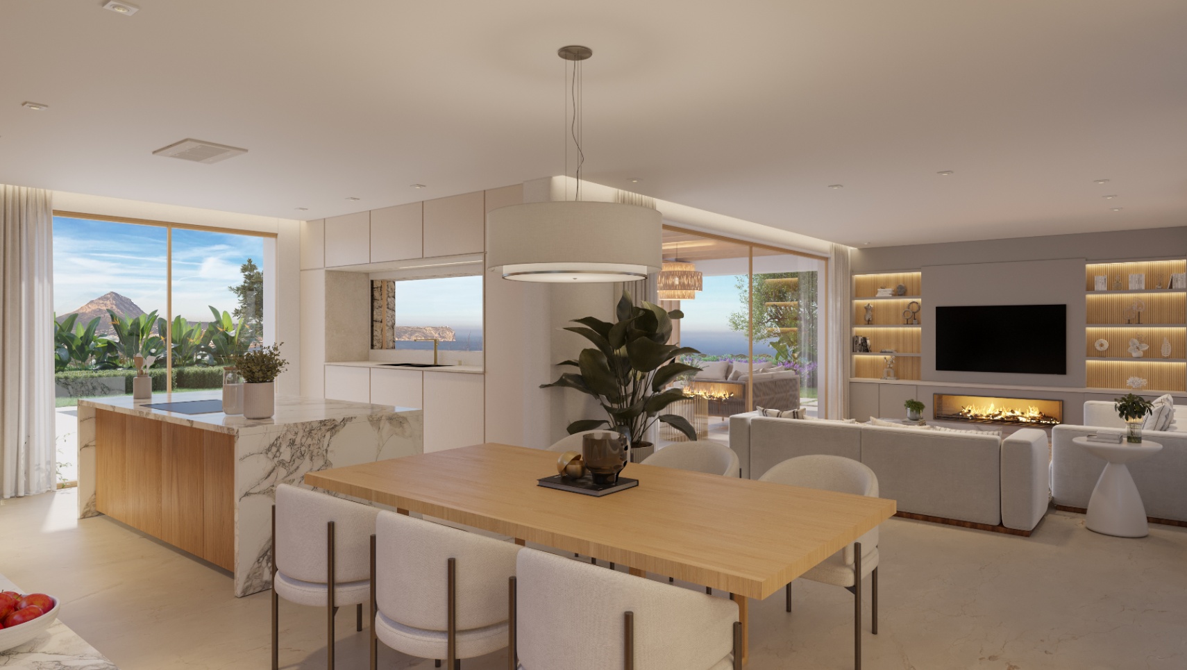 Salón-comedor de planta abierta con isla de mármol, mesa de madera y zona de estar con chimenea integrada y vistas al mar a través de grandes ventanales.