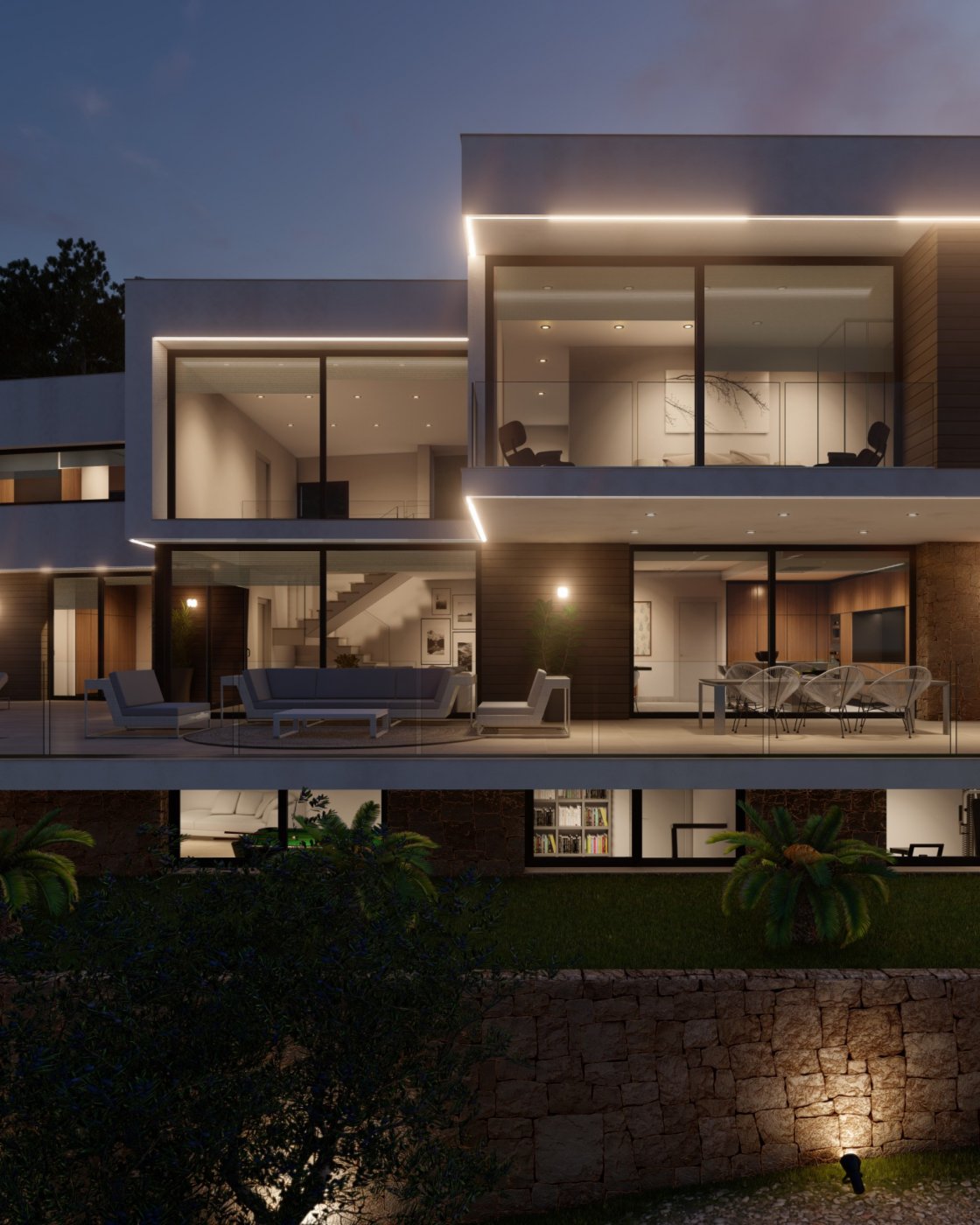 Fachada de villa moderna al anochecer con amplios ventanales, iluminación LED integrada, terraza con mobiliario de diseño y muro inferior de piedra natural.
