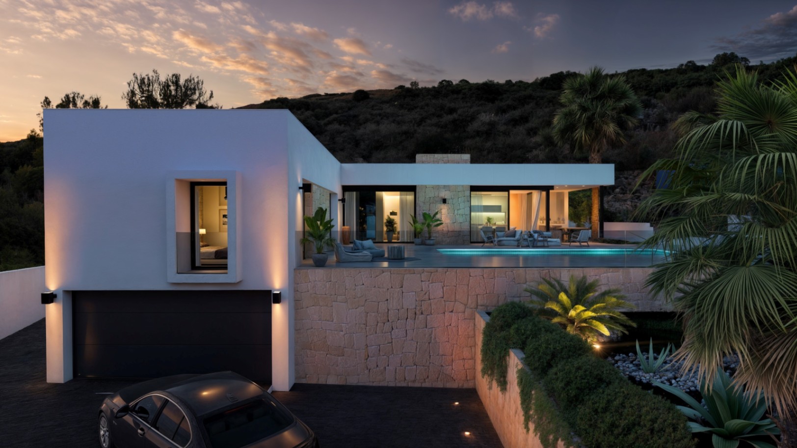 Villa moderna de dos niveles con fachada blanca, muros de piedra natural y piscina infinita. La iluminación exterior resalta el acceso al garaje y las terrazas al atardecer.