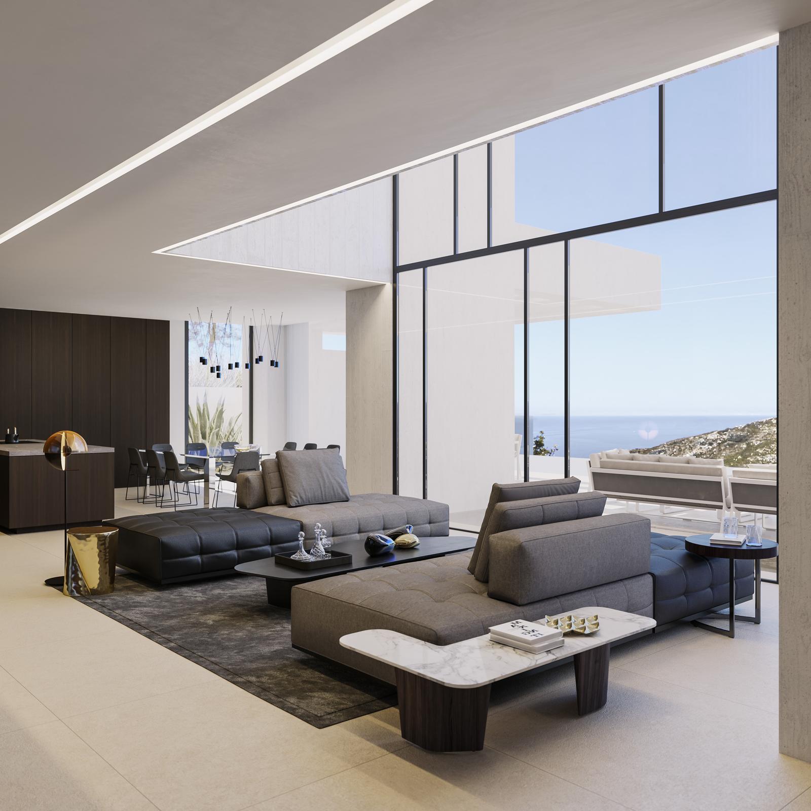 Salón de planta abierta con sofás modulares, techos de doble altura con iluminación lineal y amplios ventanales con vistas panorámicas al mar Mediterráneo.