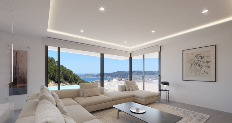 Salón de diseño con ventanales de esquina de suelo a techo y vistas al mar. Destaca la iluminación LED perimetral, el sofá modular y el suelo de gres porcelánico.